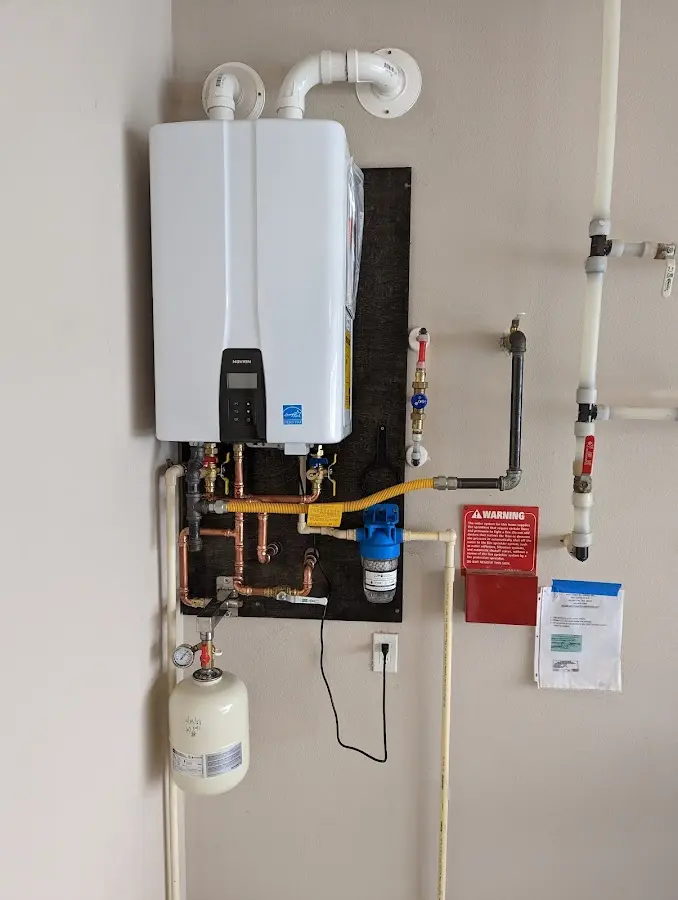 Professional plumber installing copper piping in a Carlstadt home